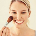 woman-applying-powder-blush