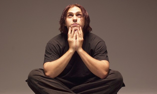 Man sitting cross legged looking up