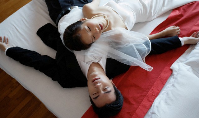 Phuket, Thailand --- Exhausted Bride and Groom --- Image by ? Ken Seet/Corbis