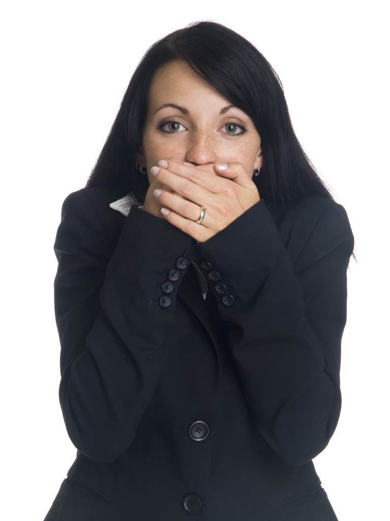 businesswoman in the Speak No Evil pose.