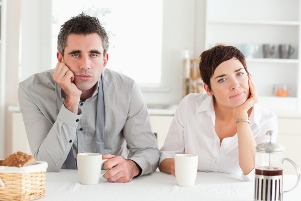 Tired couple drinking coffee