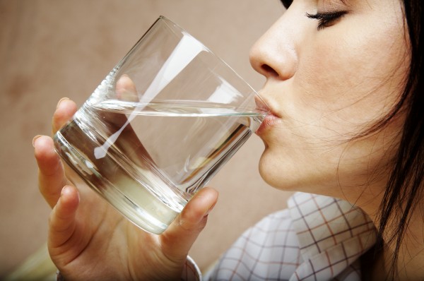 young woman with glass of mineral water