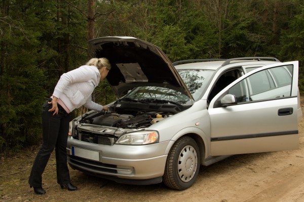 Girl with her broken silver car