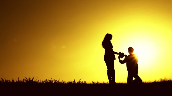 stock-footage-man-kneeling-giving-heart-proposal-love-sunset