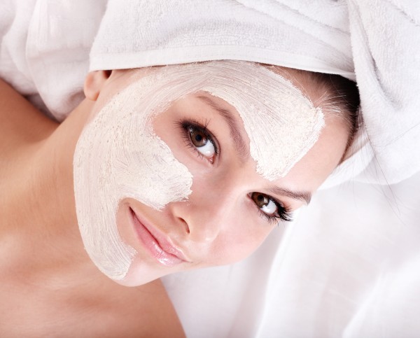 Girl with clay facial mask.