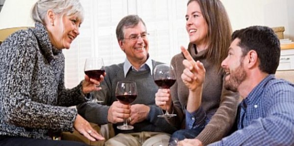 young-couple-having-wine-with-parents