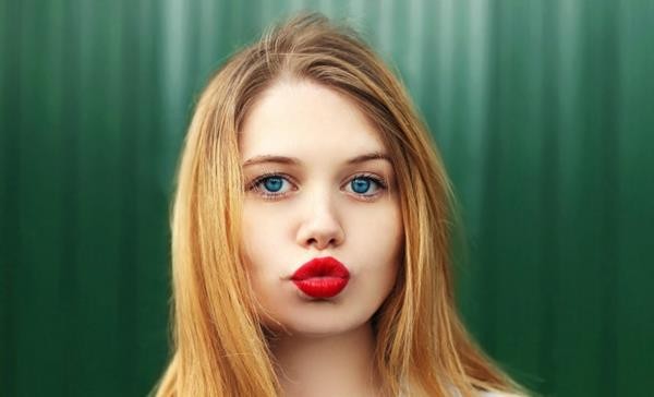 stock-photo-portrait-blonde-young-girl-with-red-lipstick-blowing-lips-342956579