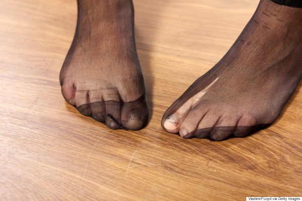 Woman's feet with torn stockings