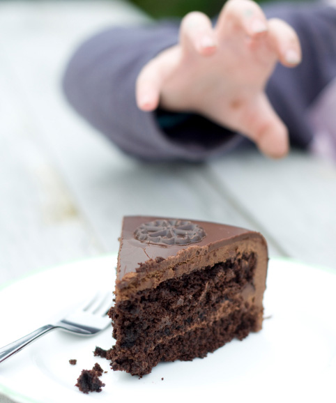 Child grabs cake