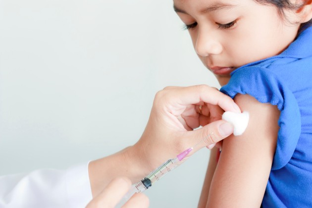 Boy and vaccine syringe