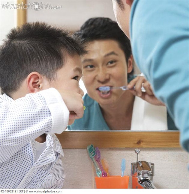 Father Teaching Son to Brush Teeth