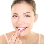 bigstock-Lipstick-makeup-woman-putting-51008723