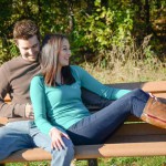 rustic-engagement-photo-of-couple-sitting-on-park-bench