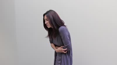 stock-footage-menstruation-pain-or-stomach-trouble-woman-hand-holding-her-belly-side-view