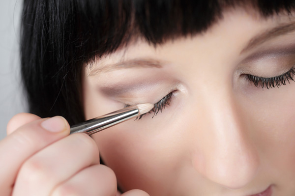 woman-applying-shimmery-eyeshadow