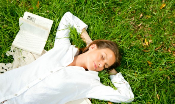 woman-day-dreaming-on-grass-588x352