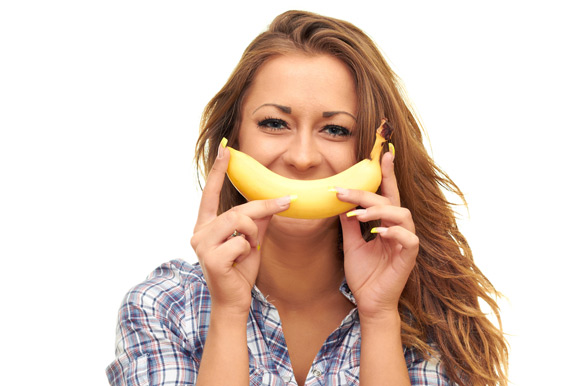 girl-isolated-on-white-background-holding-a-banana-near-the-mouth
