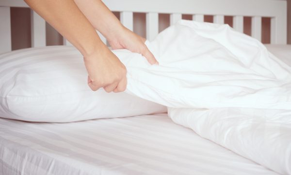 The hands of housewives who are changing sheets in hotels.